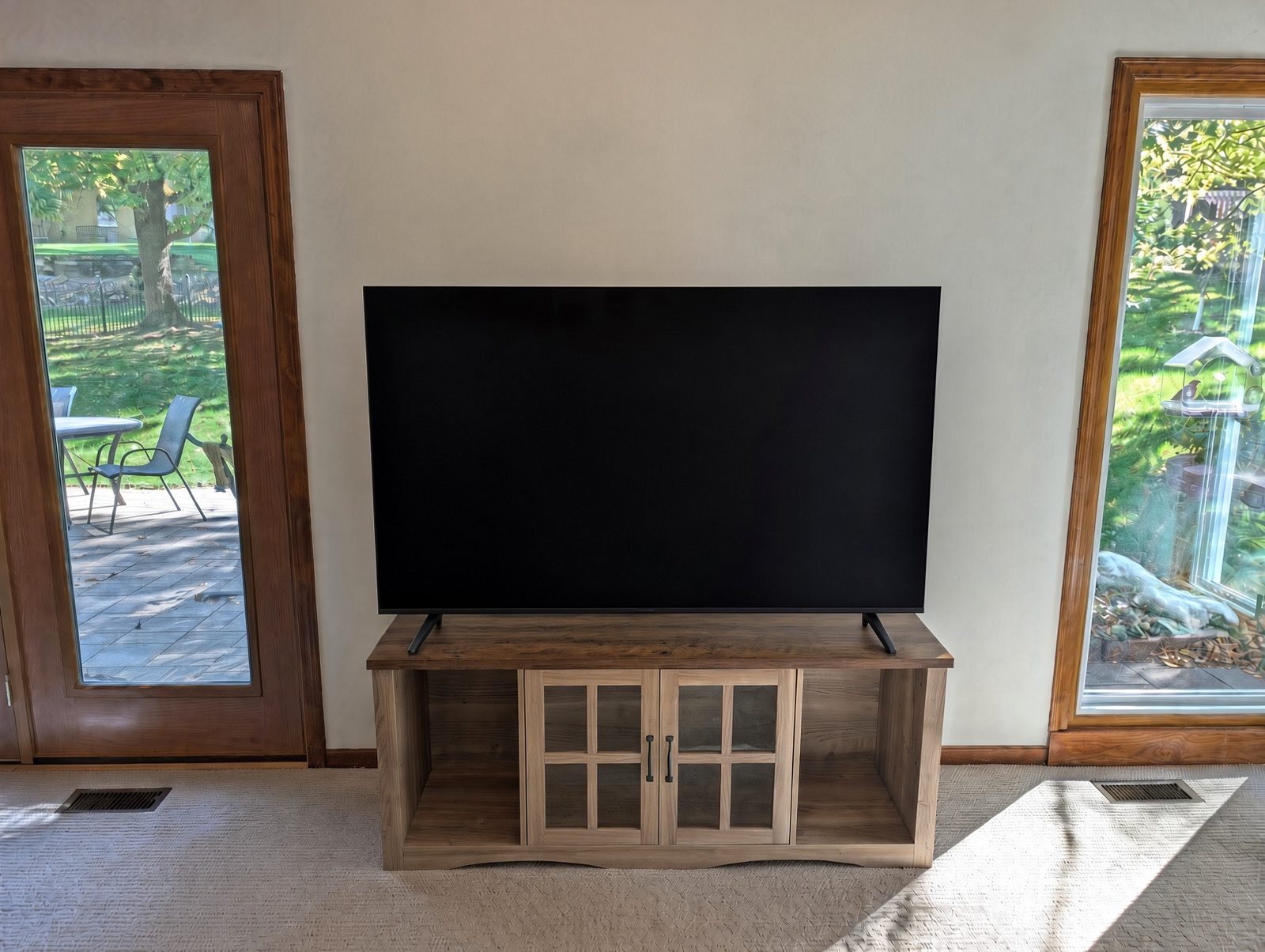 A flat-screen TV with a blank screen on its stand on a console before mounting. A flat-screen TV with a blank screen on its stand on a console before mounting.